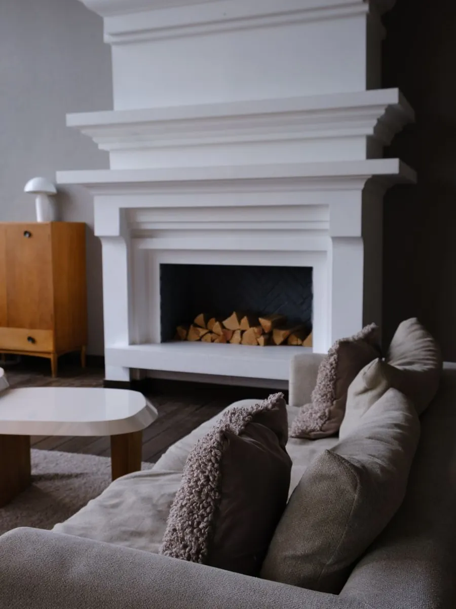 Living room with a fireplace and soft armchairs