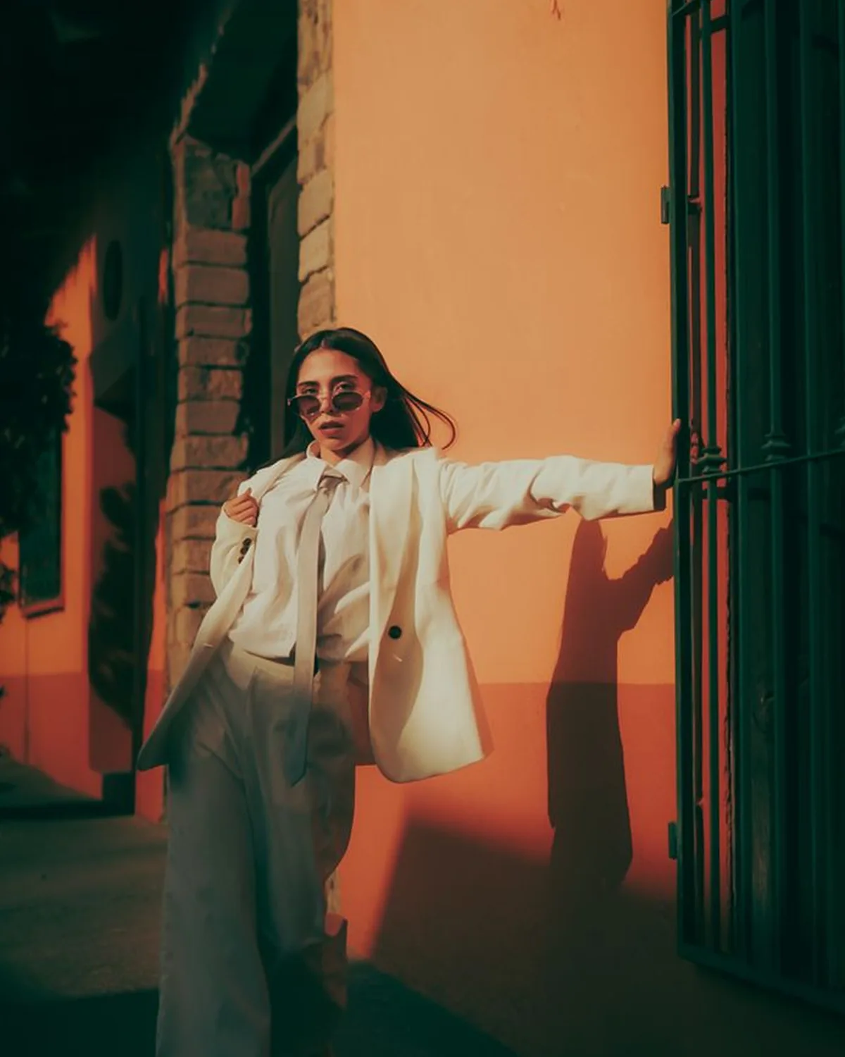 Cream suit, orange wall