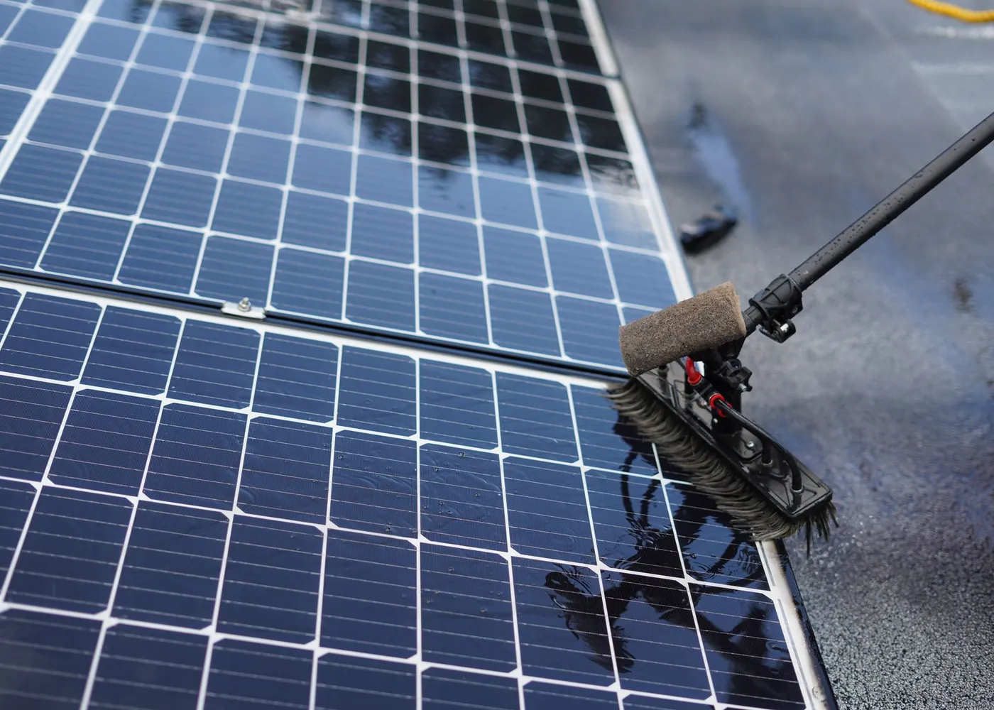 Technician cleaning solar panels