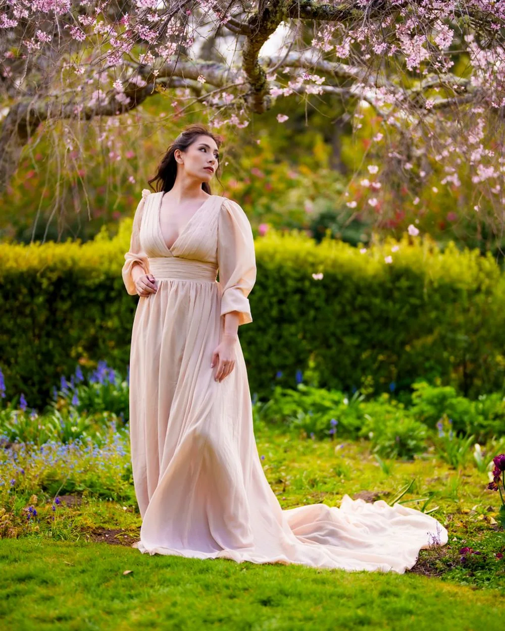A blush gown on a summer lawn