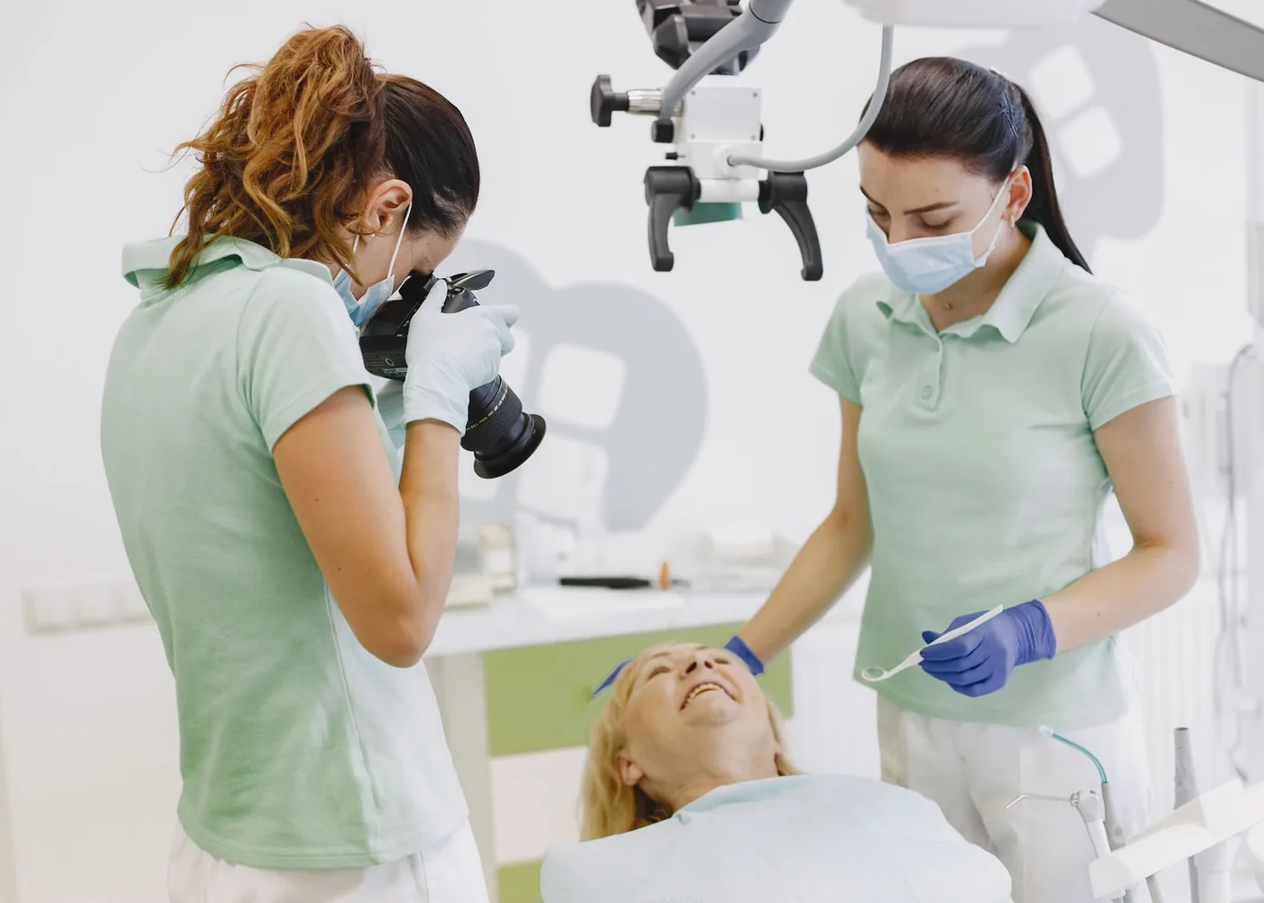 Two clinicians caring for a patient in the treatment room