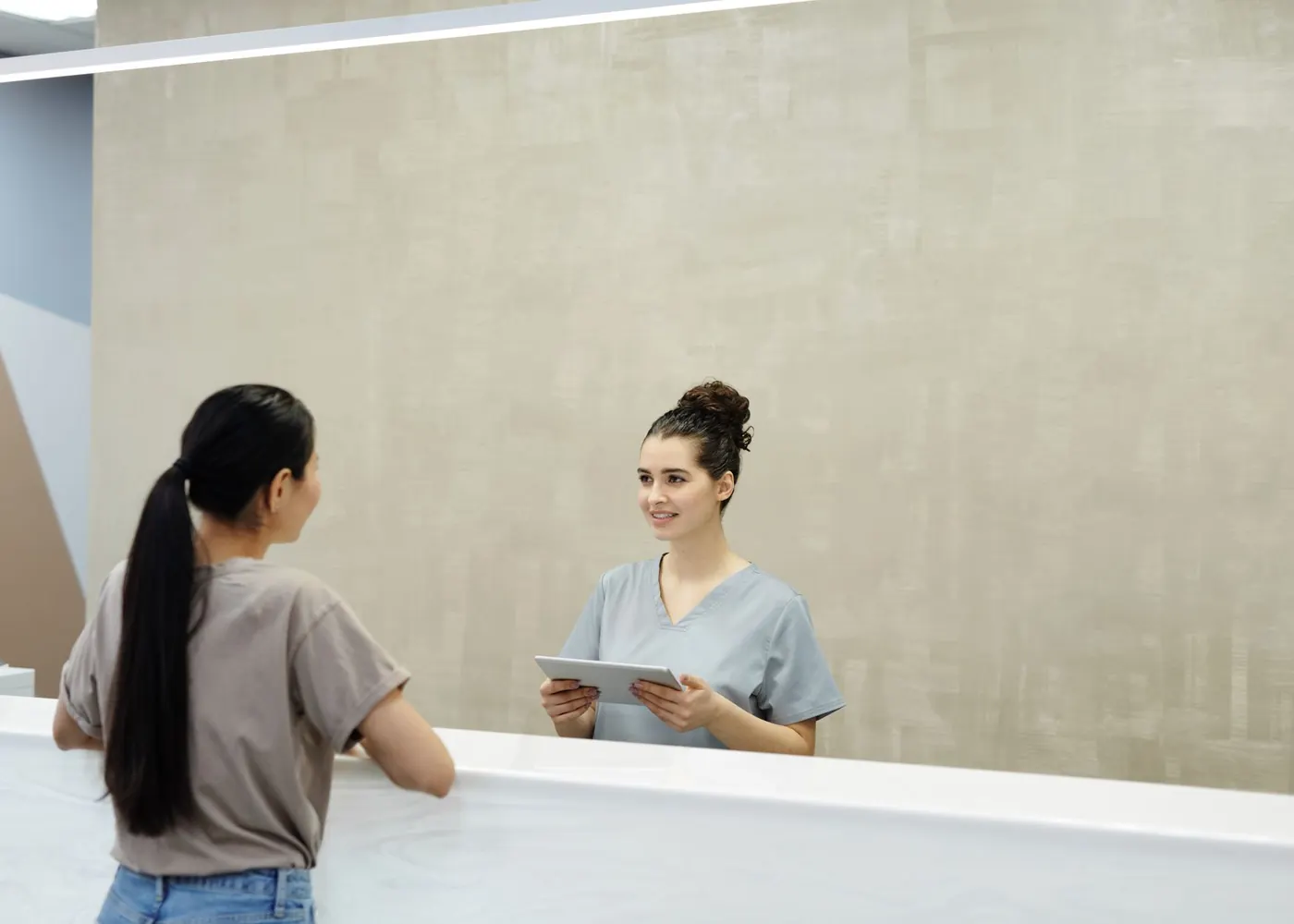 A patient at the Medivale front desk