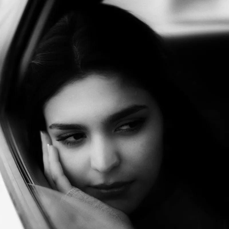 Black-and-white portrait by a window, from the studio's archive