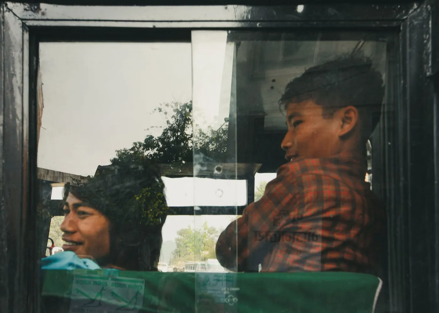 Travellers smiling at a bus window