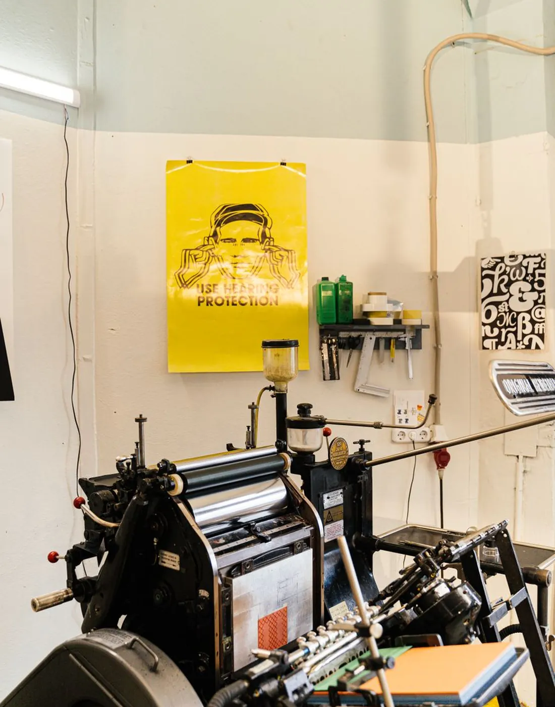 A print press and fresh posters in the studio