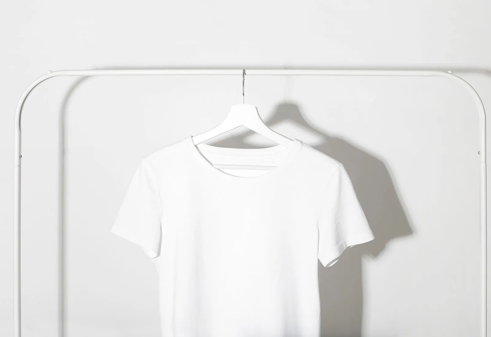 Linen shirts hanging in a dark wardrobe